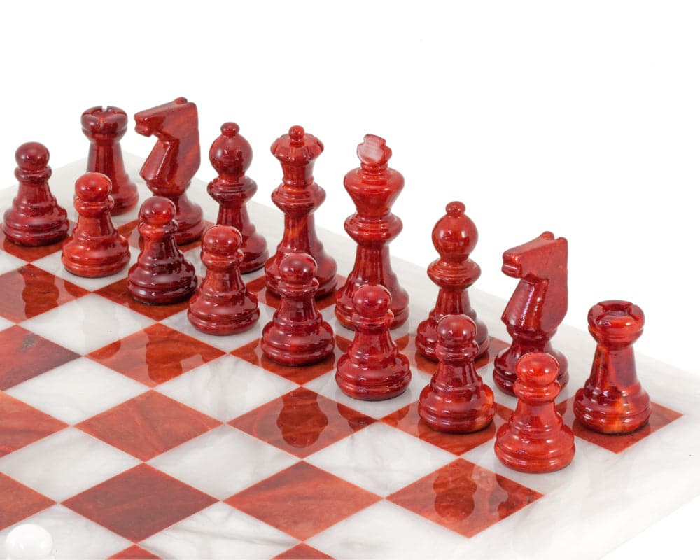 Red and white alabaster chess set from Italy, featuring detailed red chess pieces on a beautifully polished board.