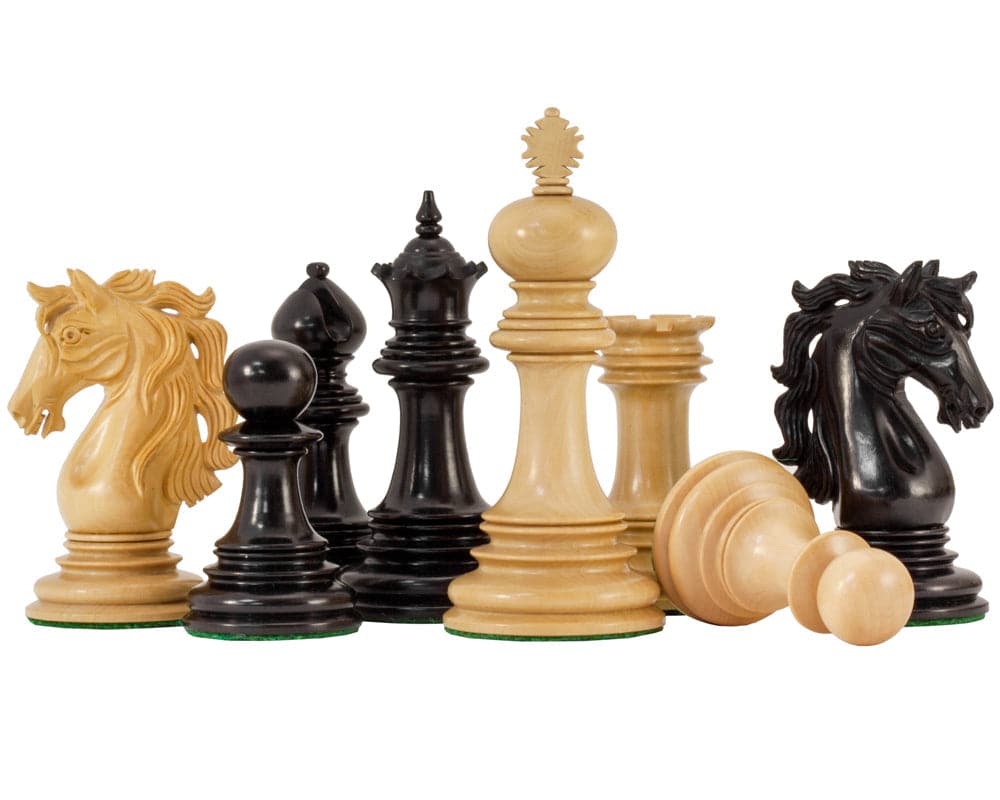 Ornate Staunton ebony chess pieces with horses, knights, and pawns on white background.