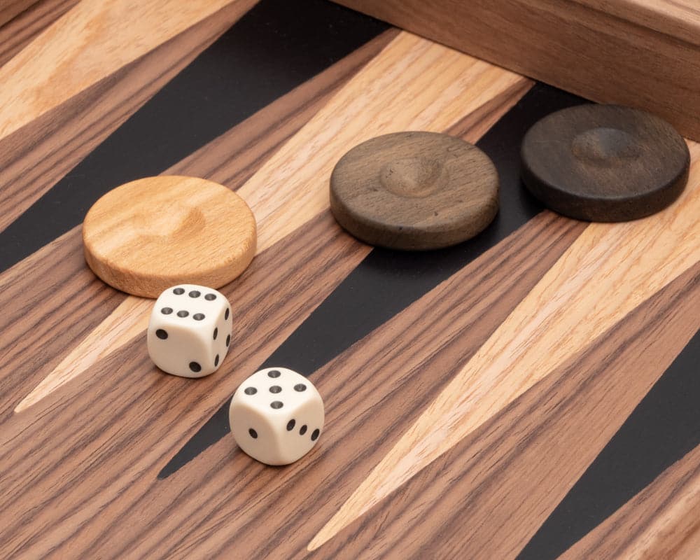 Close-up of Tournament Walnut & Maple Backgammon Set with dice and wooden stones on inlaid playing surface