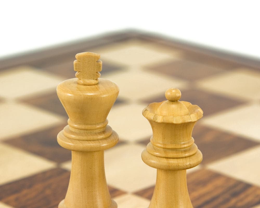 Down Head Knight Ebonised Staunton chess pieces in boxwood on a chessboard, showcasing the 3-inch king and queen.