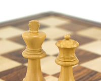 Down Head Knight Ebonised Staunton chess pieces in boxwood on a chessboard, showcasing the 3-inch king and queen.