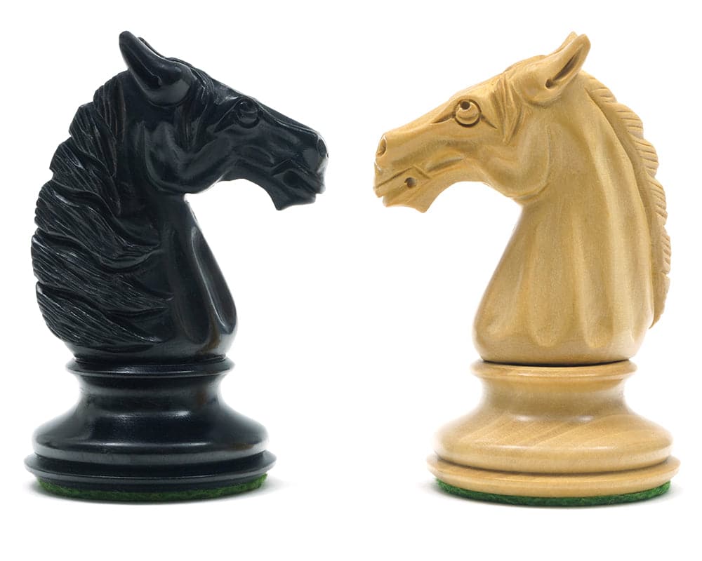 Traditional Staunton ebony wood and boxwood knights from a luxury chess set, featuring exquisite hand-carved details and felted bases.