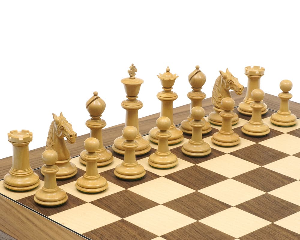 Traditional Staunton chess set with intricately carved wooden pieces in solid boxwood displayed on a checkered chessboard.