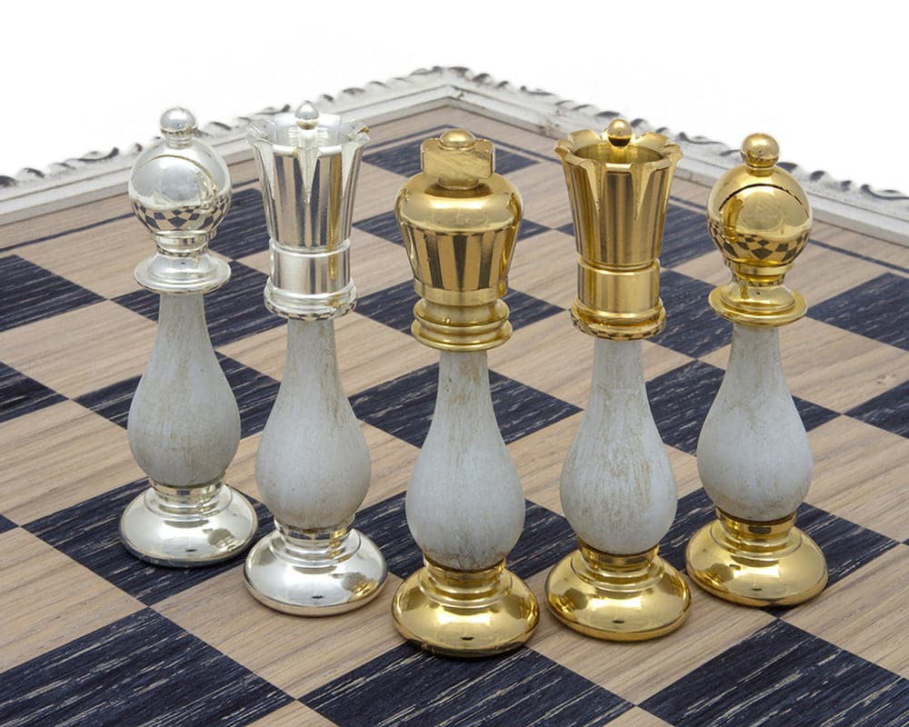 The San Severeo 24 Carat Gold and 990 Silver Plated Chessmen displayed on a chessboard