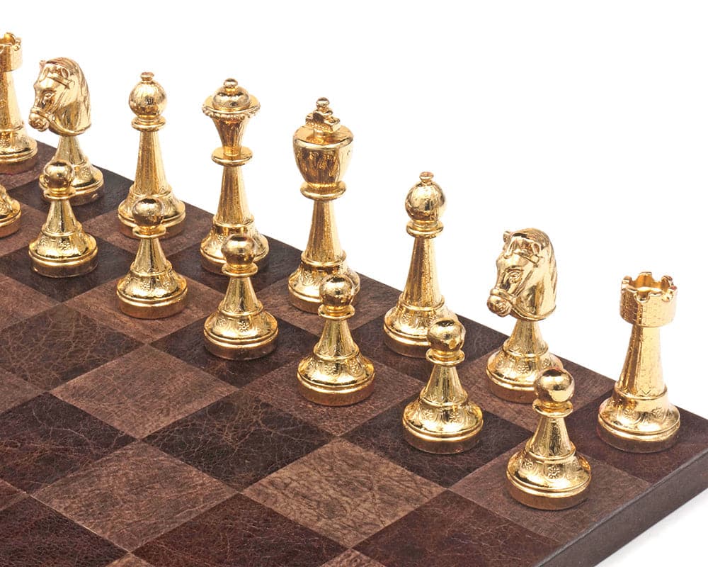 Gold and silver plated Italian chessmen on a chessboard with exquisite detail and craftsmanship, featuring a 3-inch king.