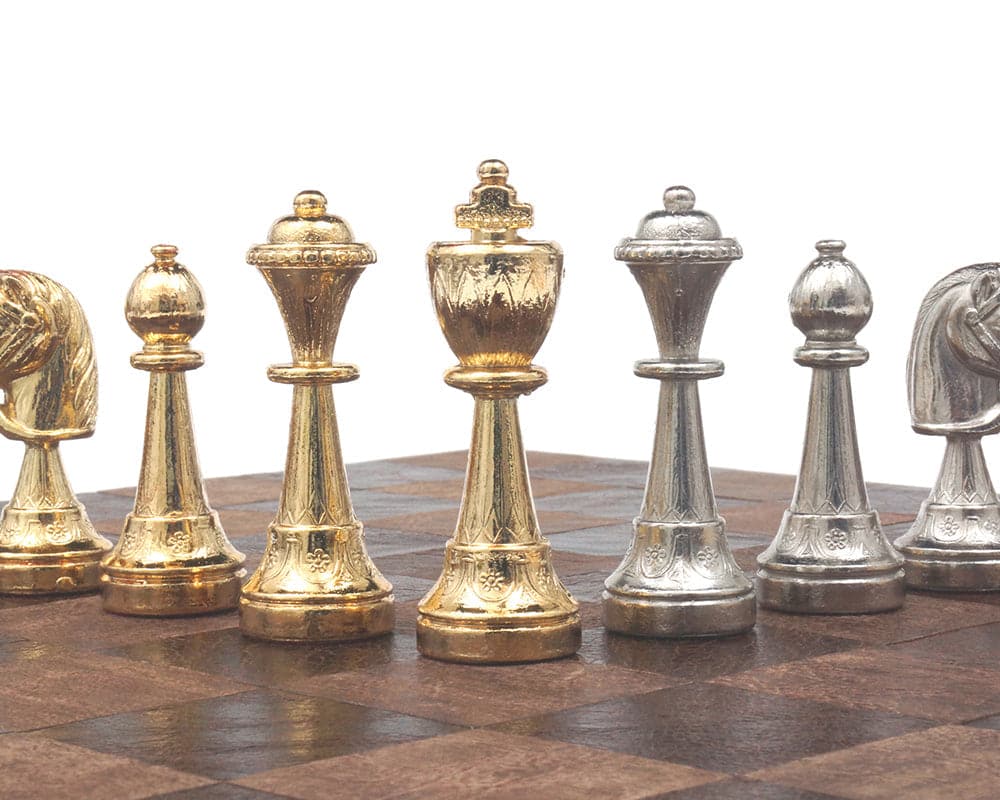 Gold and silver plated Italian chessmen set, featuring exquisitely detailed and weighted pieces with a 3-inch king on a chessboard.