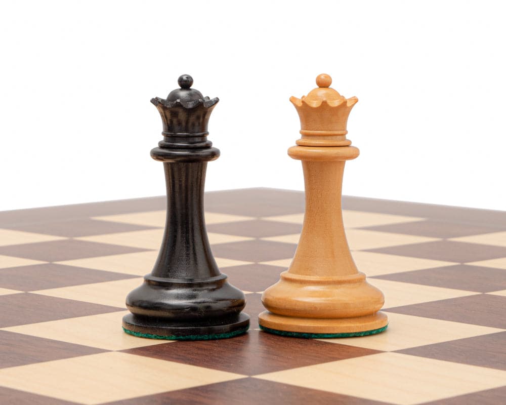 The 1853 Paulsen Reproduction 3.5 inch chess queens in ebony and boxwood on a chessboard.