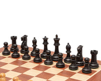 The Warwick Series 3 inch Ebonised Staunton Chessmen displayed on a chessboard with beautifully carved boxwood pieces.