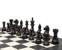 Fierce Knight Ebonised Chessmen 4 Inch on chessboard, crafted from boxwood, weighted and felted, with 4 inch king, two additional queens.