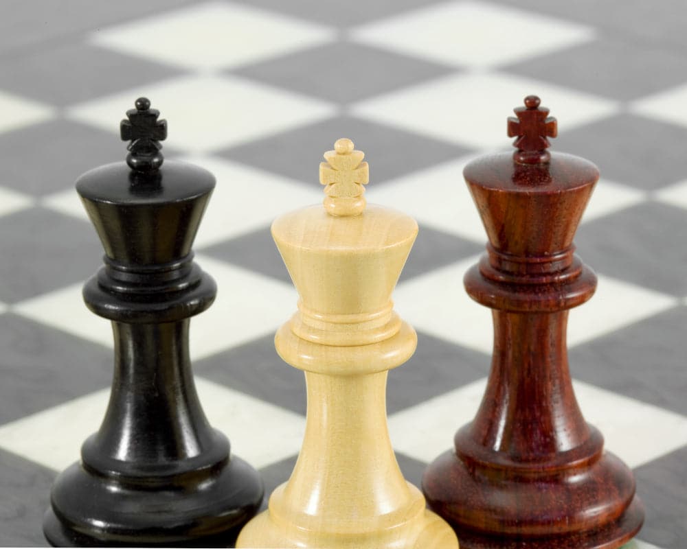 Sandringham Tres Corone luxury chess pieces in ebony, boxwood, and red sandalwood on Italian chess board