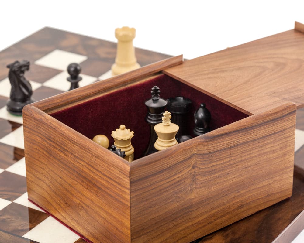 Highclere Ebony and Walnut Luxury Chess Set with open wooden storage box on mahogany and birch chess board.