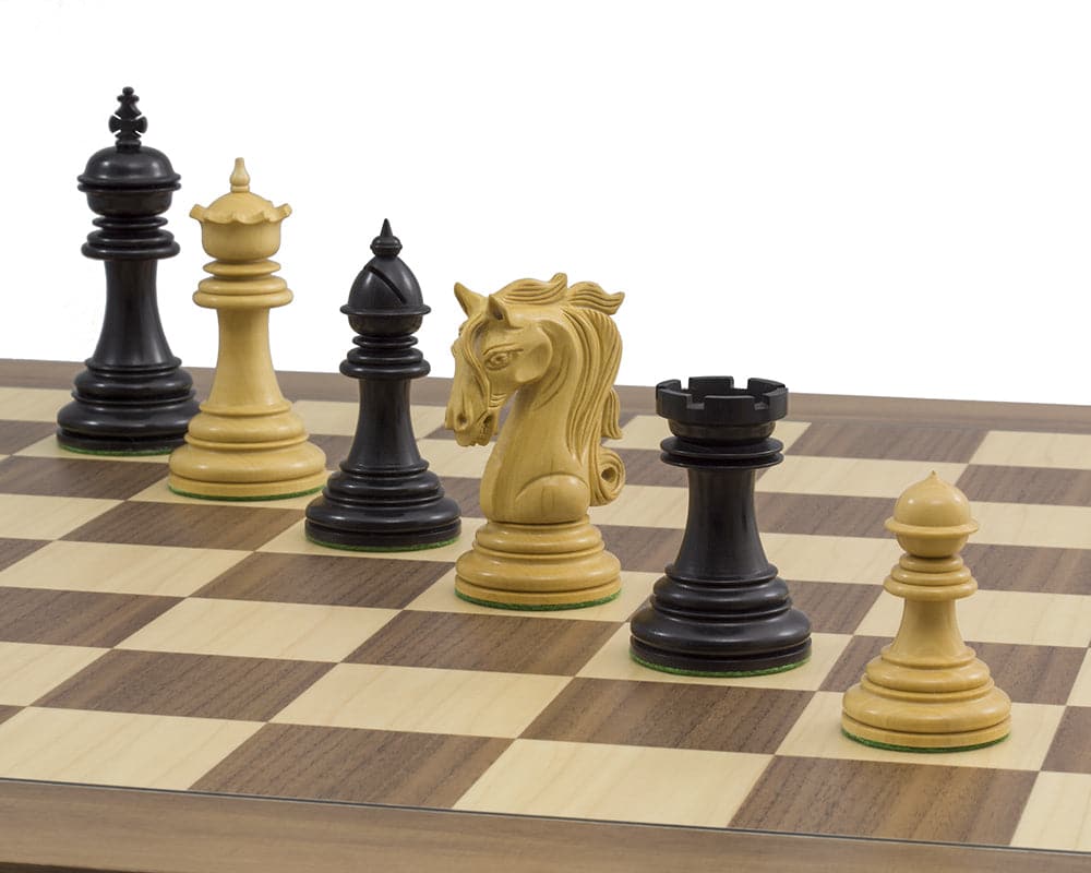 The Kingsgate Ebony and Walnut Chess Set on deluxe walnut and maple board with ornate exotic wood chessmen.