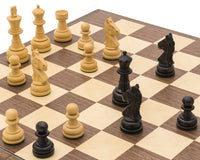 The Emerald Black and Walnut Folding Chess Set with pieces arranged on a chessboard