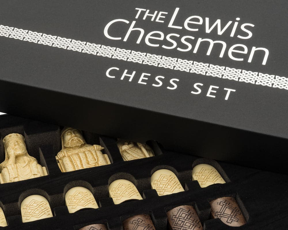 Isle of Lewis Chess Men in elegant gift packaging showing intricately detailed chess pieces and stylish box.